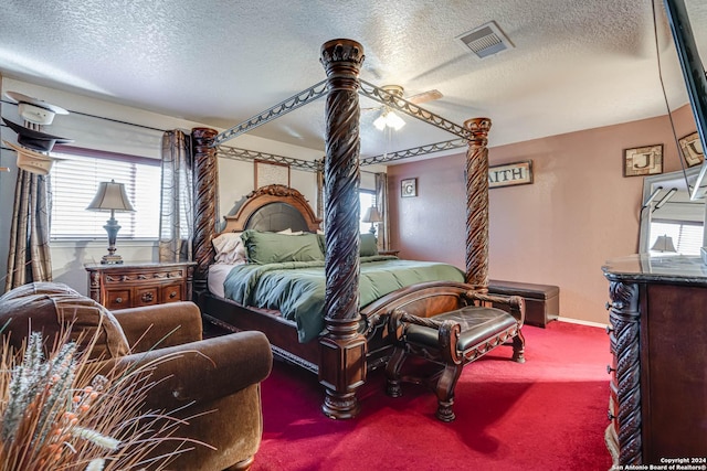 carpeted bedroom featuring a textured ceiling and ceiling fan