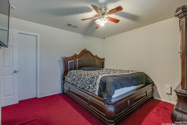 carpeted bedroom featuring a textured ceiling and ceiling fan