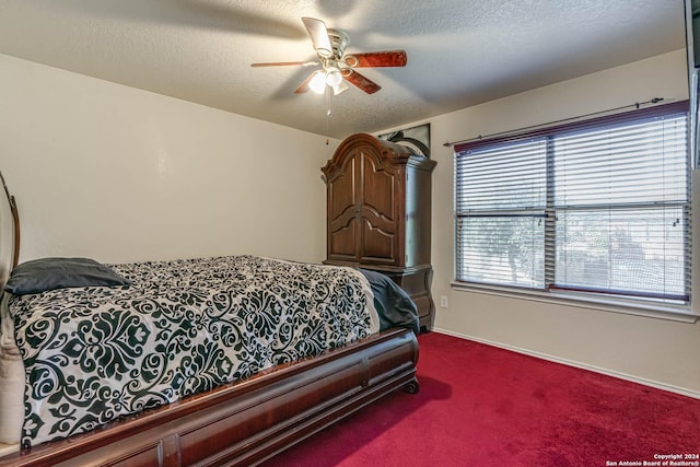 bedroom featuring ceiling fan, carpet, and a textured ceiling