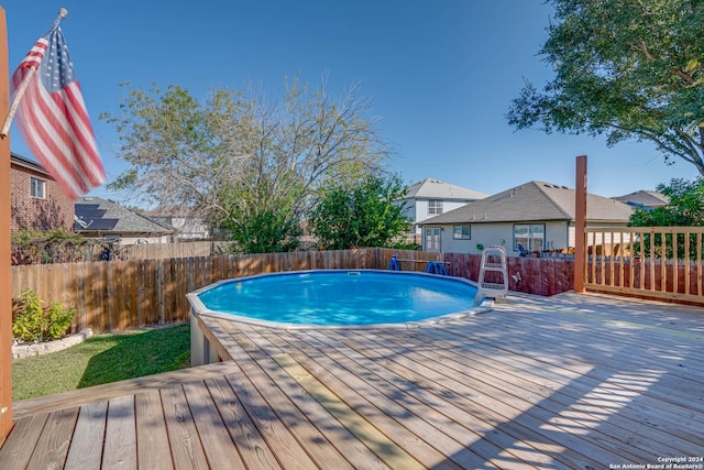 view of swimming pool with a deck