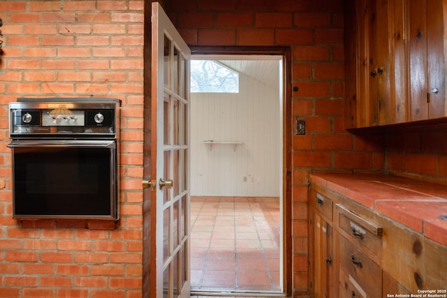 kitchen featuring wall oven and tile counters