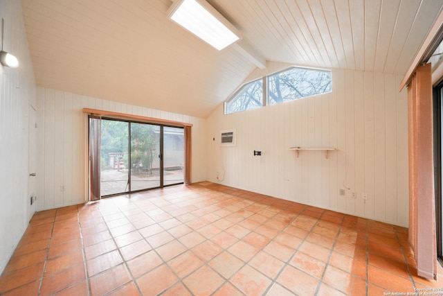 tiled spare room with vaulted ceiling with beams, a wall mounted AC, and wood walls