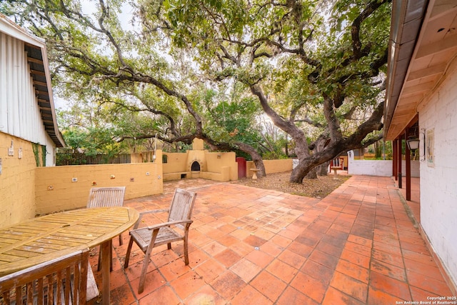 view of patio featuring exterior fireplace