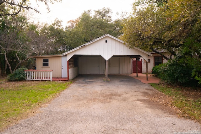 view of front of house with a garage and a carport