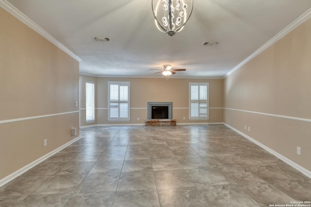 unfurnished living room with ceiling fan with notable chandelier, a wealth of natural light, and crown molding