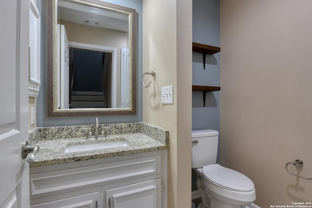 bathroom with toilet and vanity