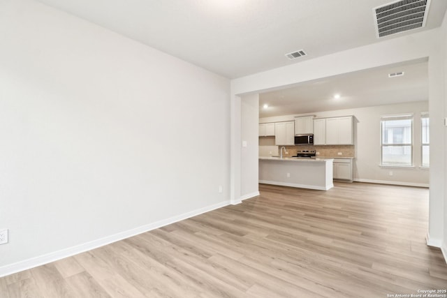 unfurnished living room featuring light wood-type flooring