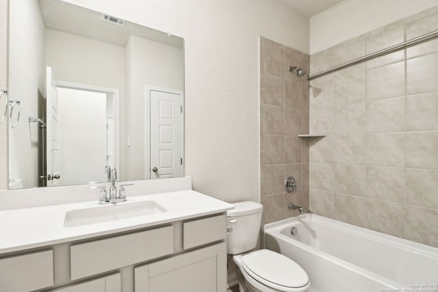 full bathroom featuring vanity, toilet, and tiled shower / bath combo