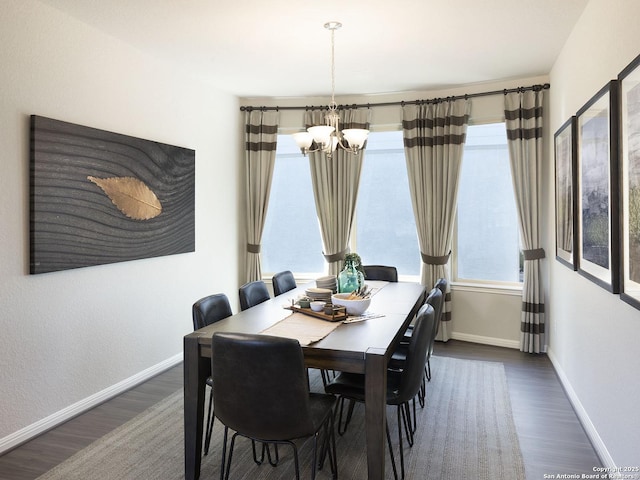 dining space with an inviting chandelier and dark hardwood / wood-style floors