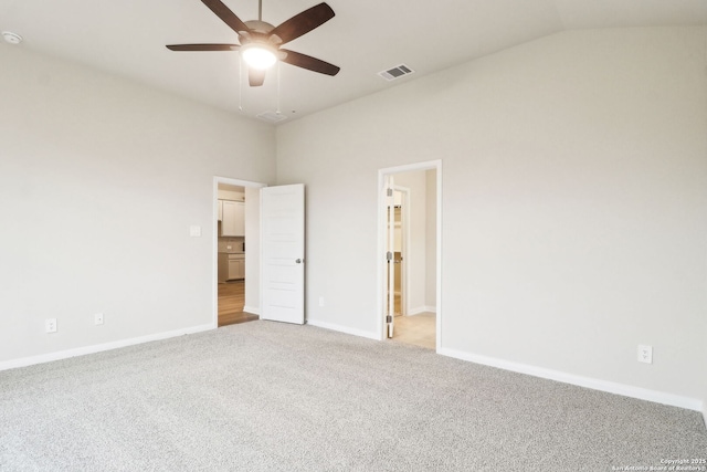 unfurnished bedroom featuring ceiling fan, light colored carpet, and vaulted ceiling