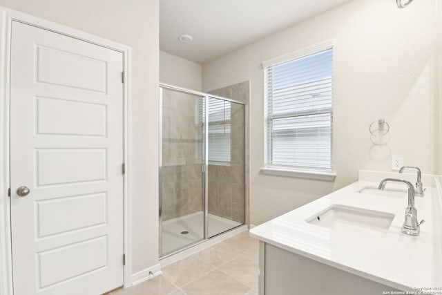 bathroom with tile patterned flooring, vanity, and an enclosed shower