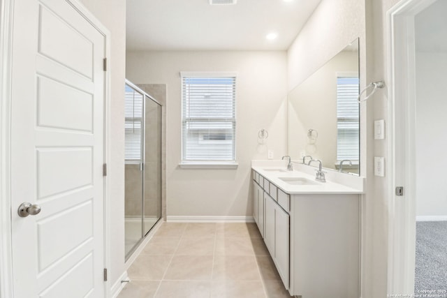 bathroom featuring tile patterned flooring, vanity, and a shower with door