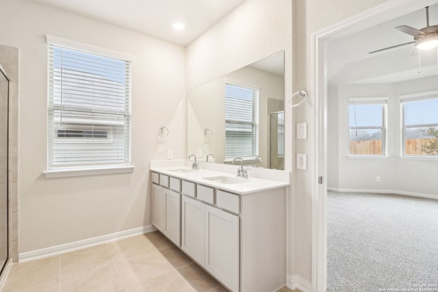 bathroom featuring ceiling fan, vanity, a shower with shower door, and tile patterned flooring