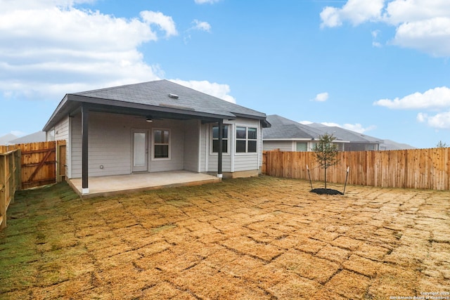 back of property featuring a patio and a lawn