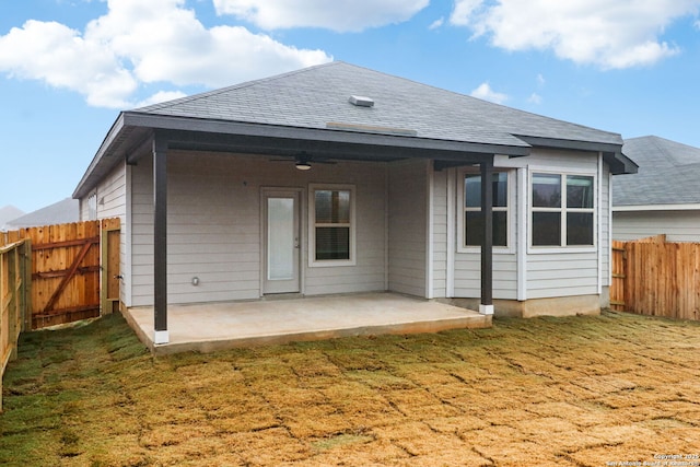 back of property featuring a yard, a patio area, and ceiling fan