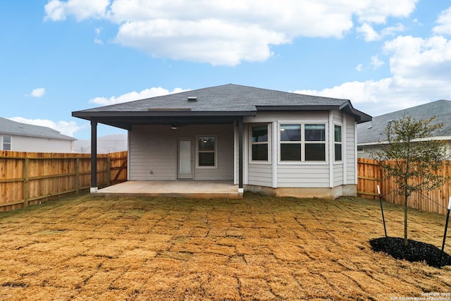 back of property featuring a yard and a patio area