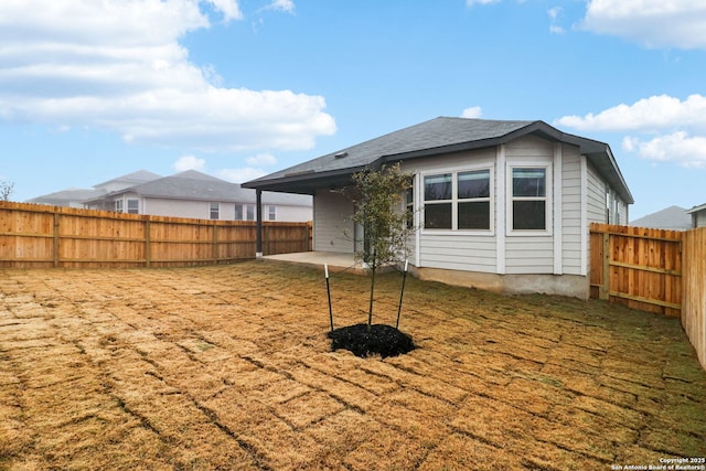 back of house featuring a yard and a patio area