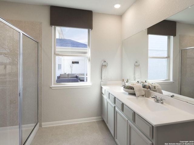 bathroom featuring vanity, a wealth of natural light, tile patterned floors, and walk in shower