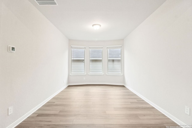 unfurnished room with light hardwood / wood-style floors