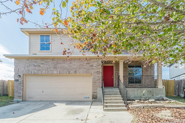 view of front of property featuring covered porch and a garage