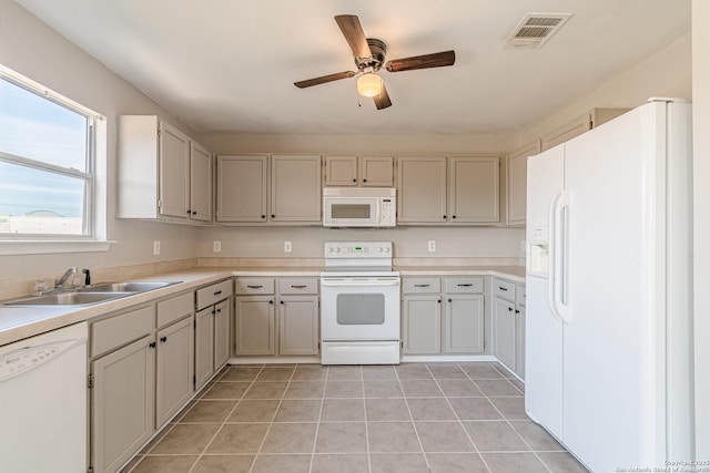 kitchen featuring ceiling fan, light tile patterned floors, sink, and white appliances