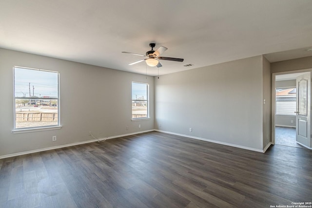 empty room featuring ceiling fan and dark hardwood / wood-style floors