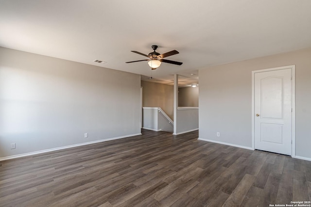 empty room with ceiling fan and dark hardwood / wood-style flooring