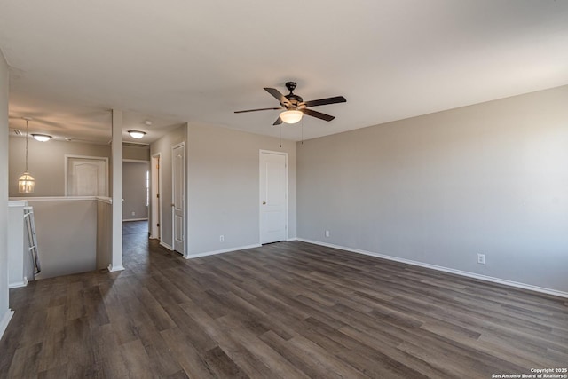 empty room featuring ceiling fan and dark hardwood / wood-style floors