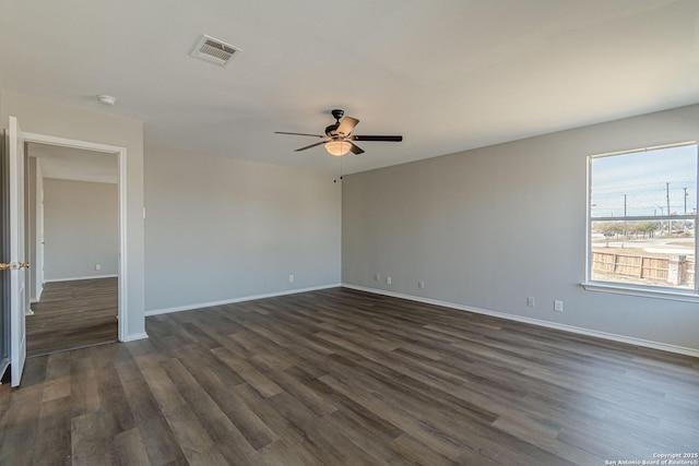 spare room with ceiling fan and dark hardwood / wood-style flooring