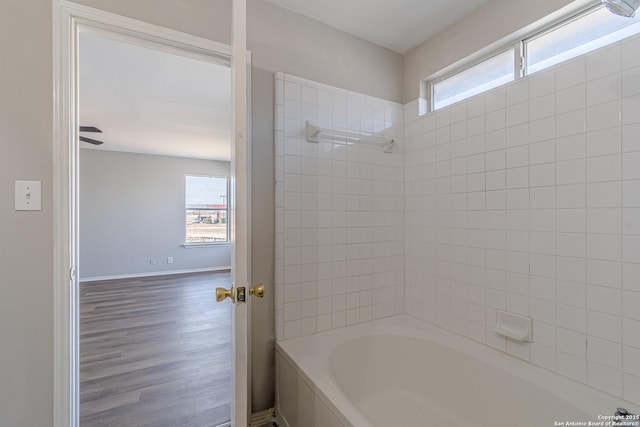 bathroom with hardwood / wood-style floors and shower / tub combination