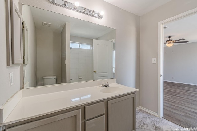 bathroom featuring ceiling fan, toilet, and vanity