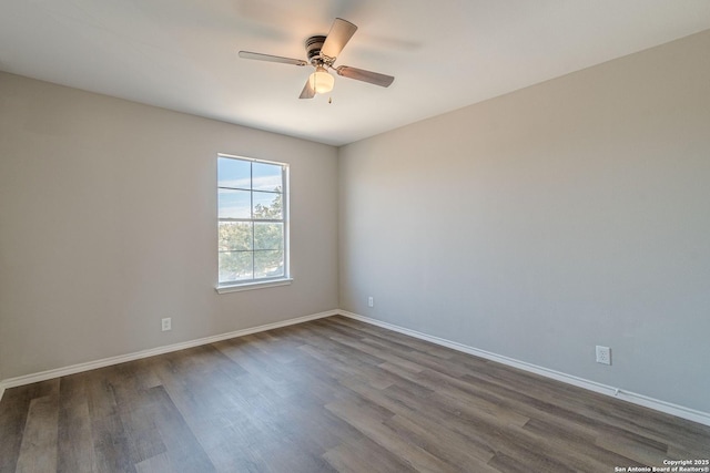 empty room featuring dark wood-type flooring and ceiling fan