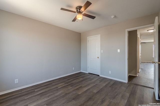 unfurnished bedroom featuring ceiling fan, dark hardwood / wood-style flooring, and a closet