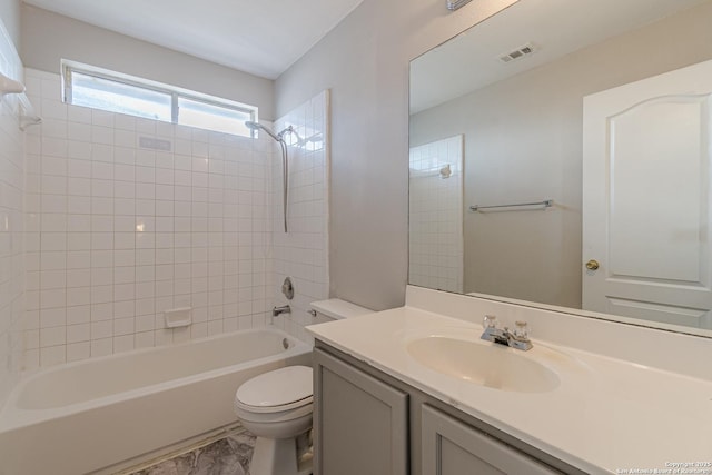 full bathroom with toilet, vanity, and  shower combination