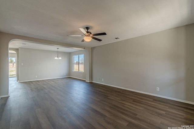 unfurnished room with dark hardwood / wood-style flooring and ceiling fan with notable chandelier