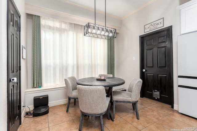 dining room featuring light tile patterned flooring and ornamental molding