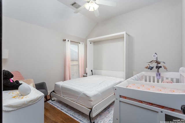 bedroom with ceiling fan, lofted ceiling, and dark hardwood / wood-style floors