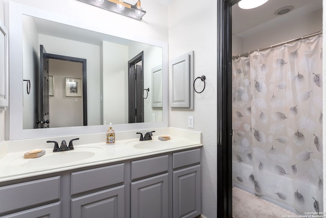 bathroom with walk in shower and vanity