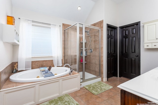 bathroom featuring tile patterned floors, vanity, plus walk in shower, and vaulted ceiling