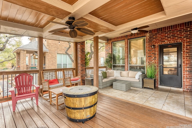 wooden deck with ceiling fan and an outdoor living space