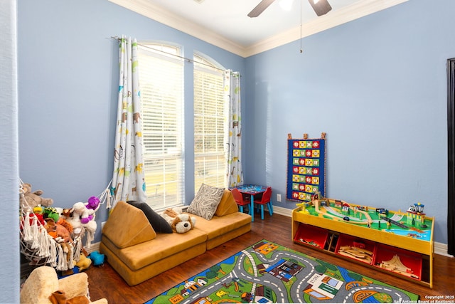 recreation room with ceiling fan, ornamental molding, and dark hardwood / wood-style floors