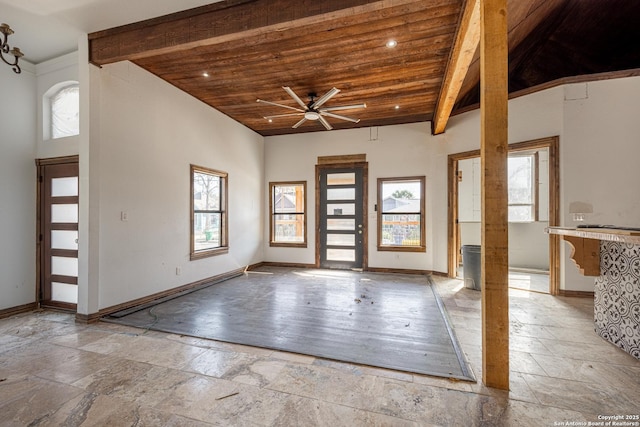 entrance foyer with wooden ceiling, a wealth of natural light, beam ceiling, and ceiling fan