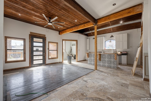 foyer entrance with beam ceiling, ceiling fan, and wooden ceiling