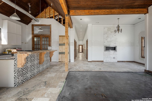 kitchen featuring pendant lighting and vaulted ceiling with beams