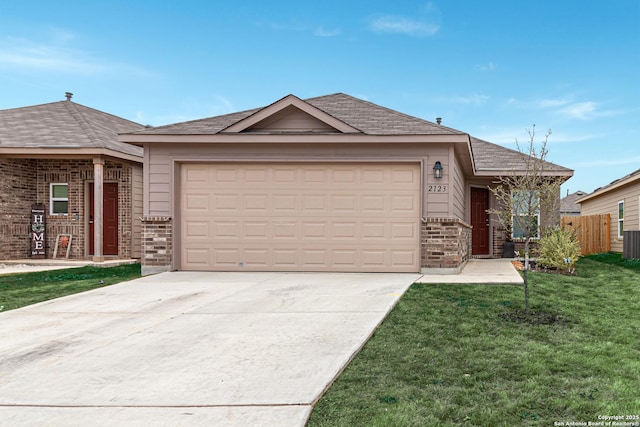 single story home with a garage and a front lawn