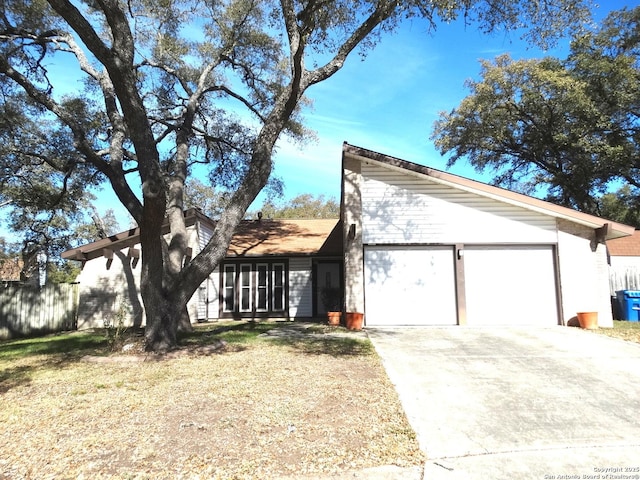 view of front of home with a front lawn and a garage