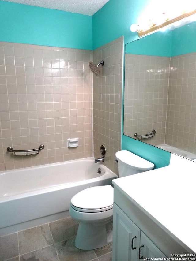 full bathroom with toilet, a textured ceiling, tiled shower / bath, and vanity