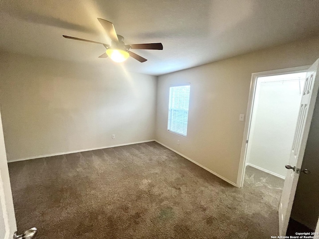 spare room featuring ceiling fan and carpet flooring