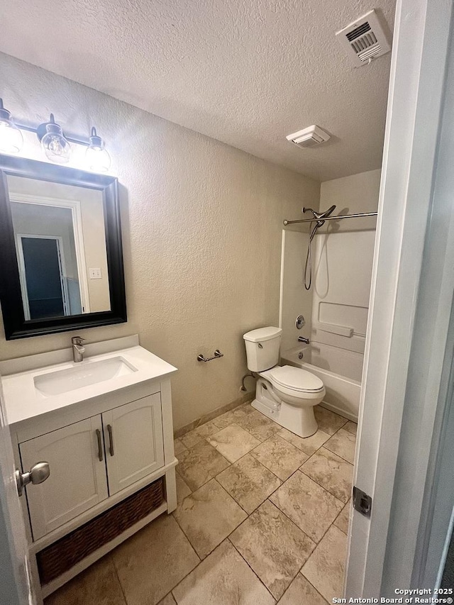 full bathroom featuring tub / shower combination, a textured ceiling, toilet, and vanity