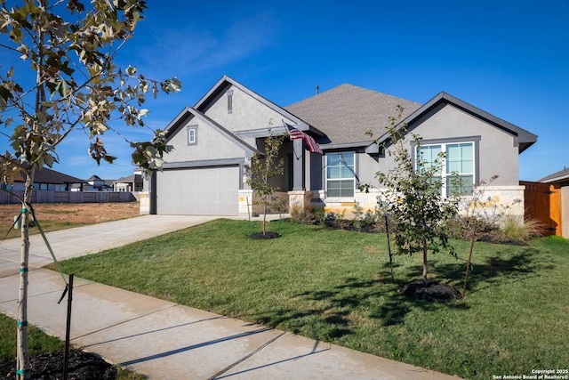 view of front of property with a front yard and a garage